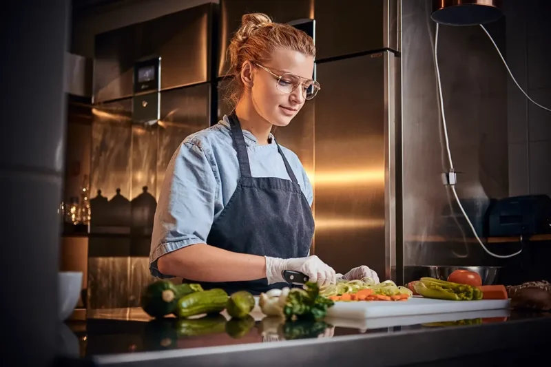 female chef in a dark restaurant