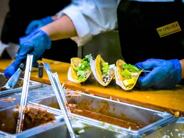 Woman filling three tacos