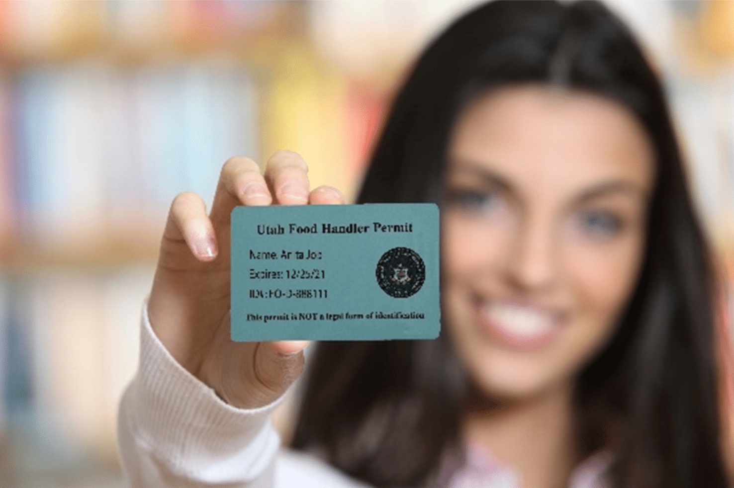 Utah food handler permit card presented by a young woman